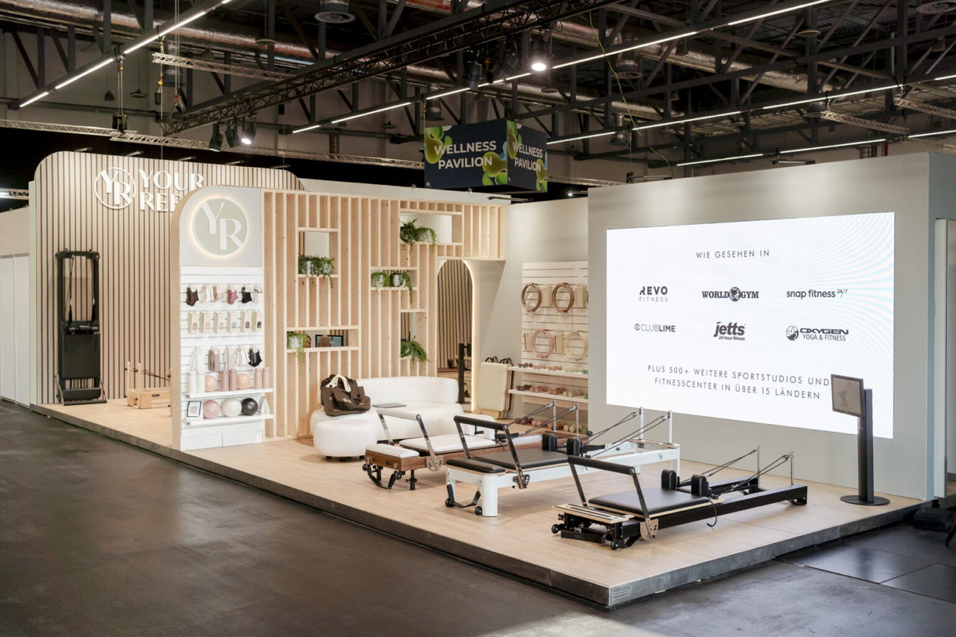 KMU und Mittelstand Messestand für Pilates- und Wellnessgeräte mit Trainingsgeräten und Markenwand
