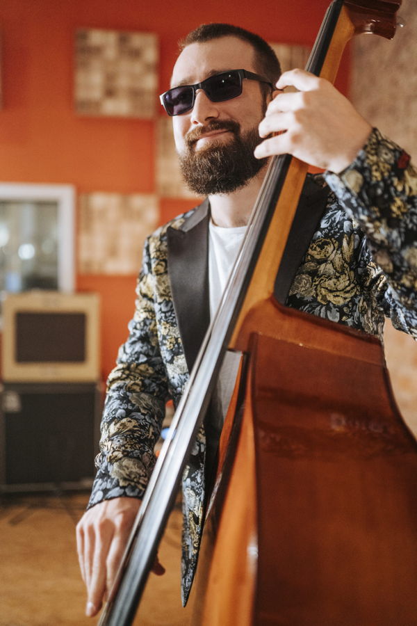 Ein bärtiger Mann mit Sonnenbrille spielt einen Kontrabass