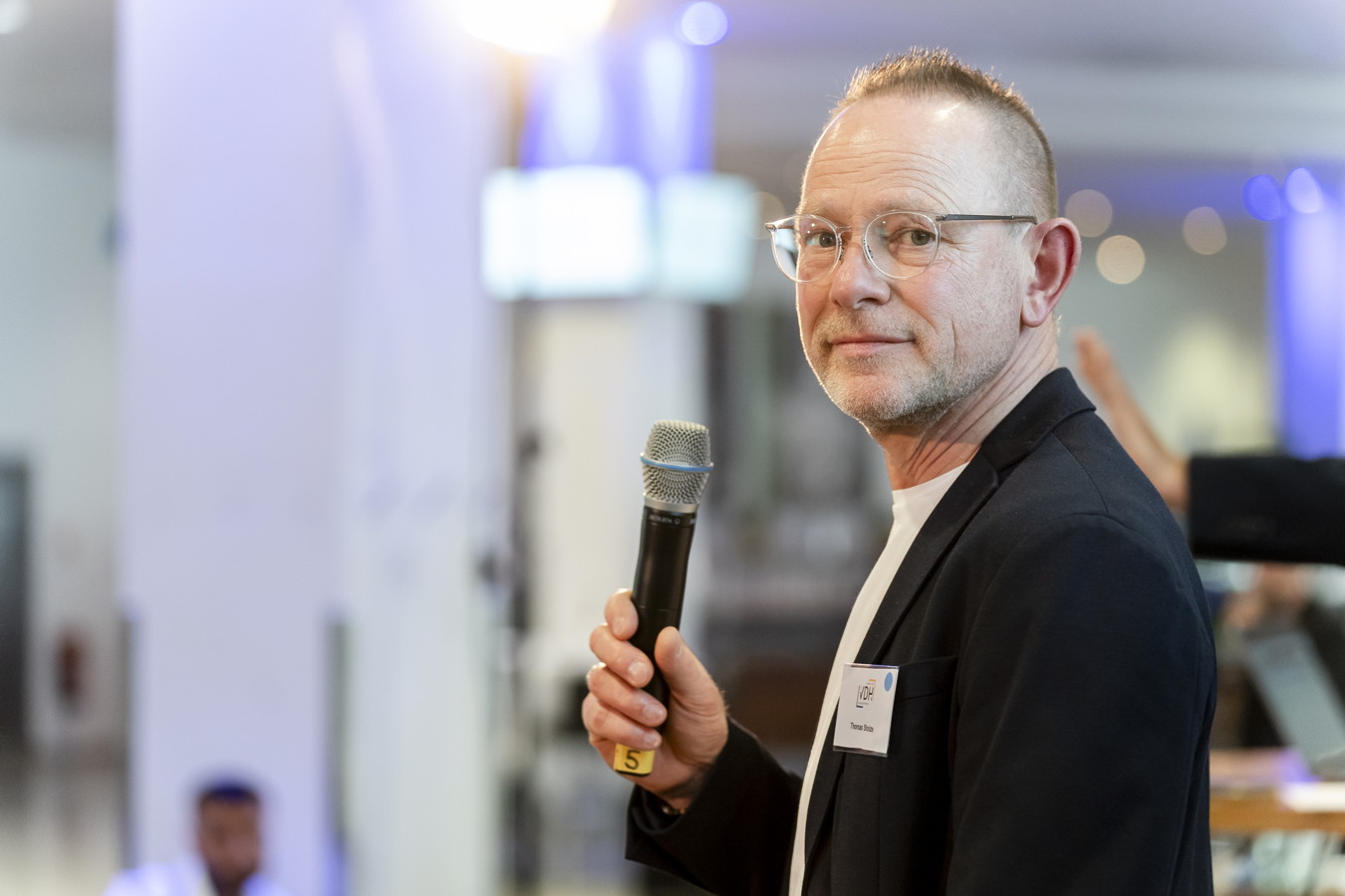 Mann mit Mikrofon bei einer Veranstaltung